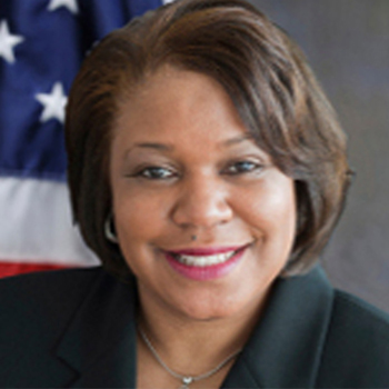 A woman in front of an american flag.