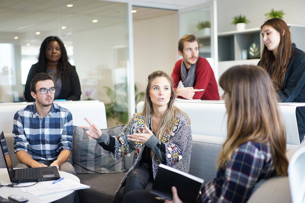 A group of people sitting around in an office.