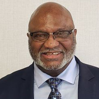 A man with glasses and a suit jacket.